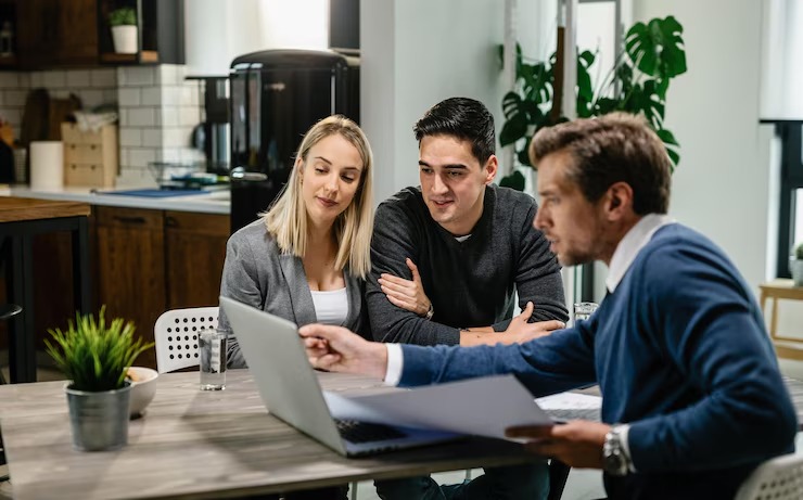 young-couple-real-estate-agent-using-laptop